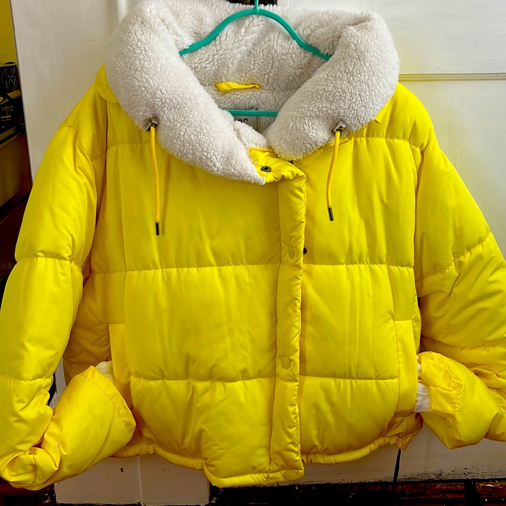 A yellow fur jacket. BDG is the brand of the product. Very warm and cozy.